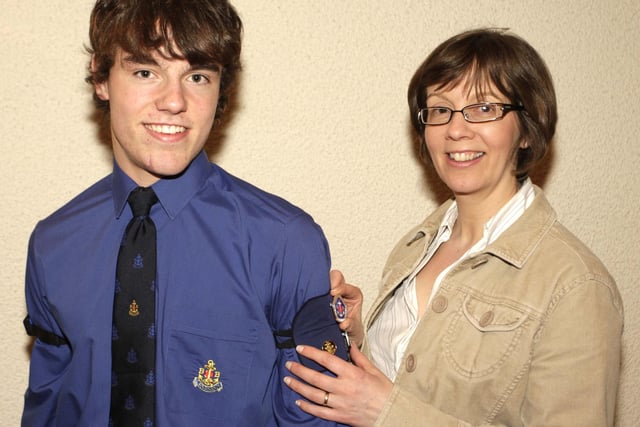 Pictured at Kilraughts BB's annual Inspection & Display in 2009 receiving his President's Badge from his Mum Wendy is member, Adam Kerr