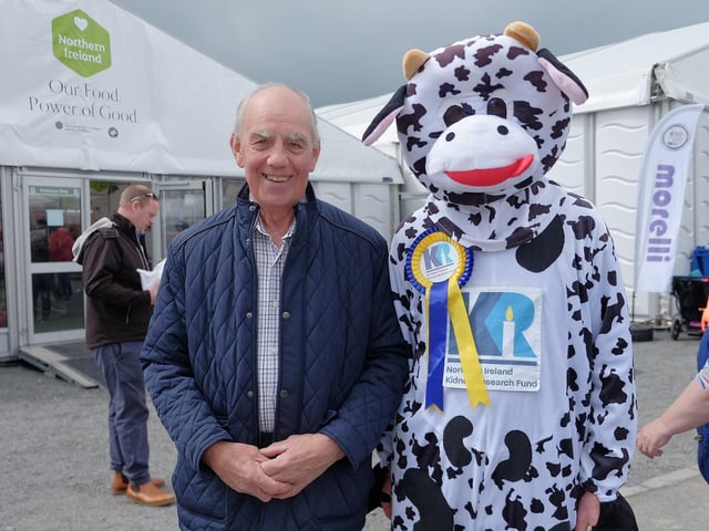 George McCall from Armagh County Show meets Northern Ireland Kidney Research Fund 's mascot Bella the Kidney Cow.
