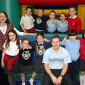 Pupils from Mossley PS and St McNissi's PS got together in 2007 for the EMU Fun 4 All day. The students are pictured with Paul Diamond from Emu, Miss Isobelle Newell of Mossley Primary School and Mrs Rhoda Mitchell of St McNissi's Primary School.