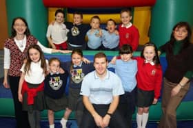 Pupils from Mossley PS and St McNissi's PS got together in 2007 for the EMU Fun 4 All day. The students are pictured with Paul Diamond from Emu, Miss Isobelle Newell of Mossley Primary School and Mrs Rhoda Mitchell of St McNissi's Primary School.