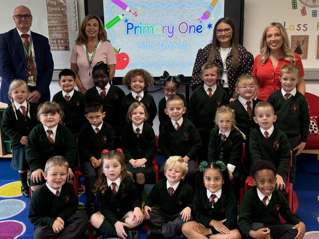 Mrs Dowey's P1 class at Millington Primary School, pictured with principal Mr Woolsey and classroom assistants Ms Williamson and Miss Thompson.