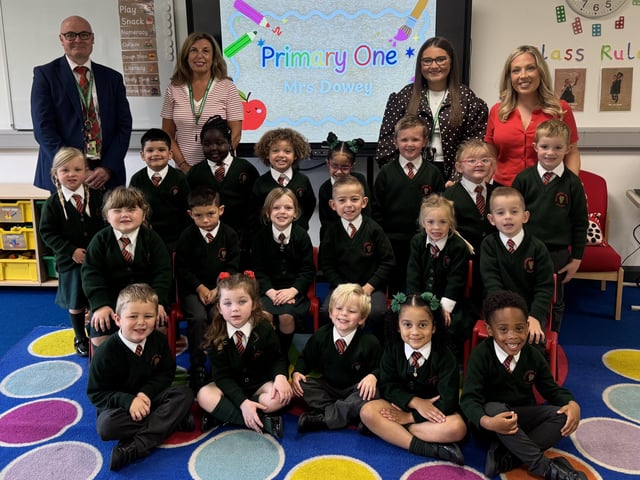 Mrs Dowey's P1 class at Millington Primary School, pictured with principal Mr Woolsey and classroom assistants Ms Williamson and Miss Thompson.