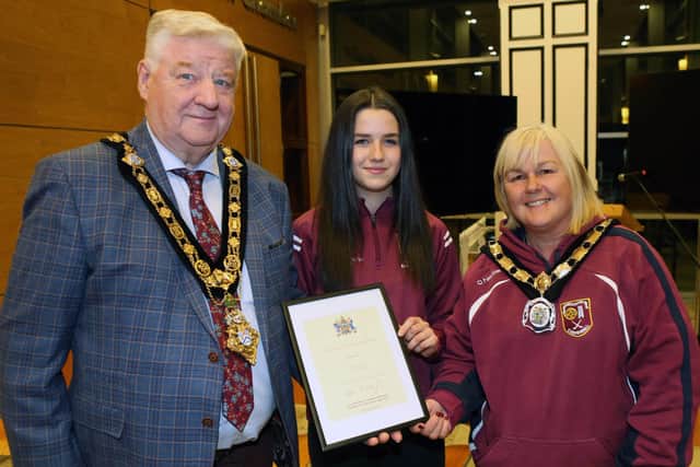 Mayor of Causeway Coast and Glens, Councillor Steven Callaghan and Deputy Mayor of Causeway Coast and Glens, Councillor Margaret-Anne McKillop alongside Ruairi Og U15 Camogie Team captain Eva McNeill. Credit Causeway Coast and Glens Council