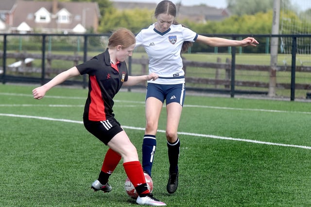 Markethill High School (white) players in action at the Electric Ireland schoolgirls soccer tournament at Lurgan Town FC on Friday. PT21-230.