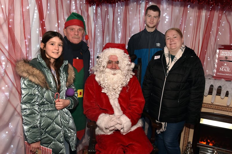 Looking happy with Santa in his grotto at St Mark's Church Tower are from left, Sophie Ford (11), David the Elf, Travis Ford and Julie Burke. PT50-225.