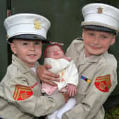 Young Drumaderg Flute Band members, Jack Robertson (3) and Tommy Morrow (9) pictured with four-month-old Darcy Robertson at the Mavemacullen Accordion Band 70th anniversary parade in Markethill on Wednesday evening. PT32-228.