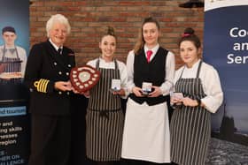 The winners from South Eastern Regional College, Nadia Rainey, Eimer McCarthy and Erin Horner, receive their gold medals from Lady Mary Peters.