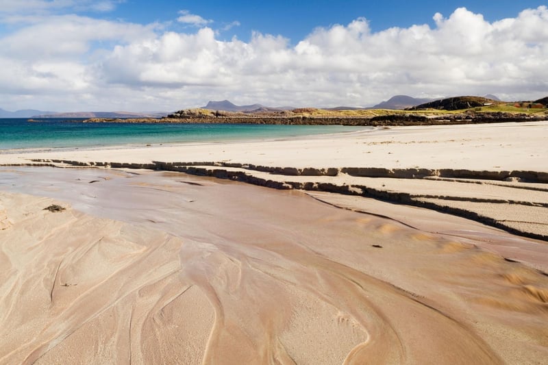 Gaze at distant Highland mountains across Gruinard Bay from this spectacular beach, with its fine silver sands, gentle dunes, and crystal clear waters. It is a hidden gem in Wester Ross, in the north west of Scotland.
