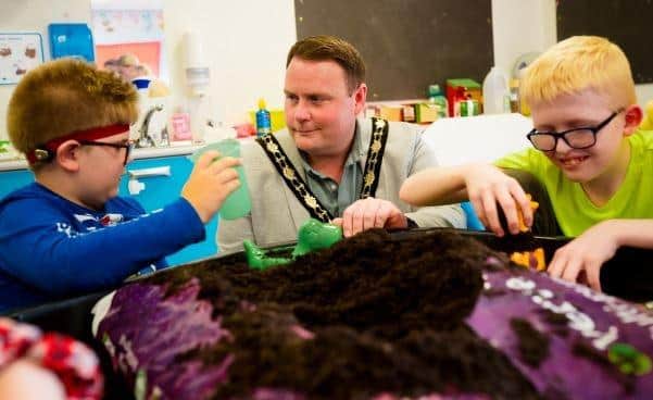 Cllr Mark Cooper enjoys some sensory play with pupils from Jordanstown School. (ANBC).