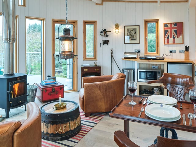 The nautical theme in the living area includes ship's flags and lanterns.
