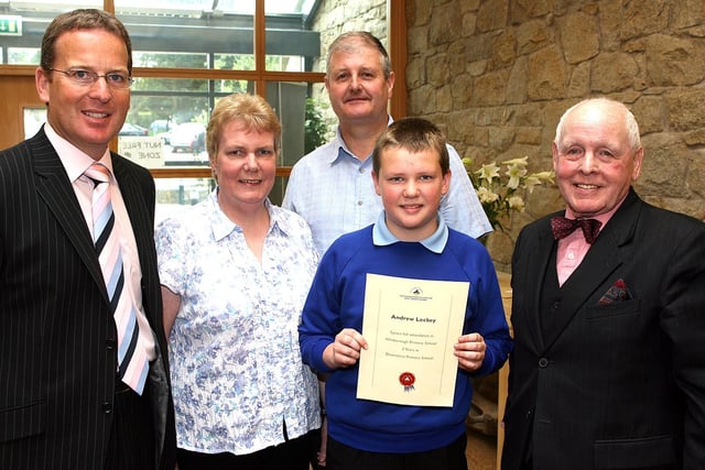 In 2007 Downshire Primary School Principal John Knaggs presented Andrew Leckey with a certificate for 7 years full attendance. Also pictured are Norman Walsh Downshire Primary School Chairman of Board Of Governers and Andrew's parents