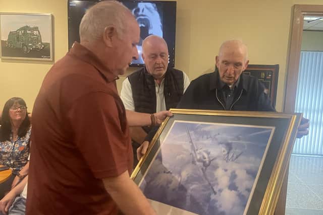Gerry presents the Chairman of the Royal British Legion in Lisburn with a framed picture which have pride of place in the Lisburn club. Pic credit: NIWD