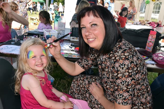 Little Izzy McCaughley (4) has her face painted by Victoria Mikelsone at Drumcree Family Fun Day on Saturday. PT23-224.