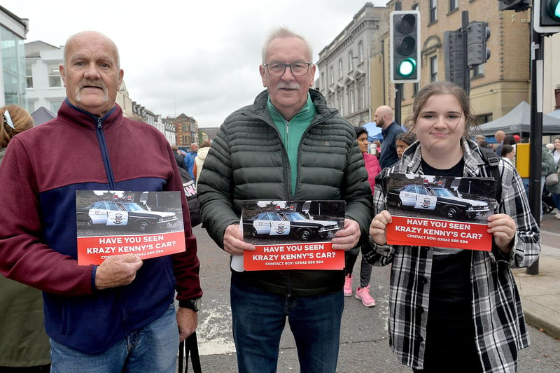 Roy Gregg, left, with William Murphy and Rebecca Gregg, is on a mission to find his late brother Kenny's missing US police car and was handing out leaflets at Country Comes To Town. PT38-206.