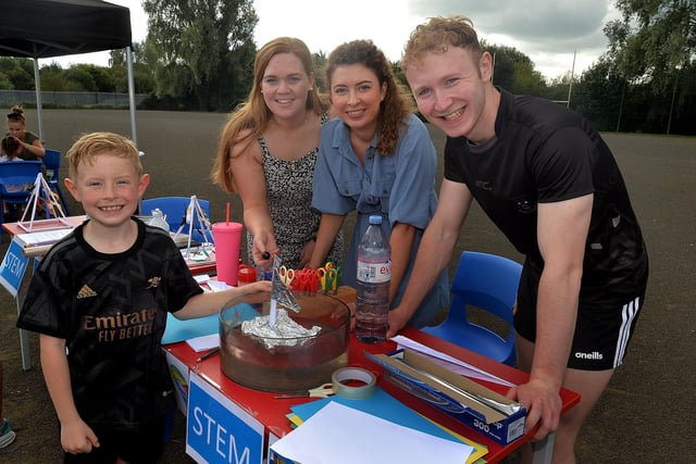 Senan Rafferty (8) tries his hand at building a foil boat during the St John the Baptist's College fun day as Emma Molloy, Megan Hughes and Darren McLaughlin look on. PT37-206.