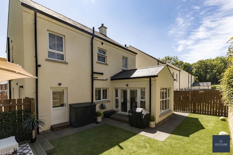 The fully enclosed rear garden is laid in artificial lawn and has a paved patio area.