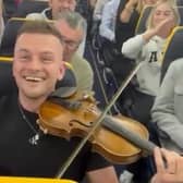 In full flow... striking up the music onboard the Ryanair flight.