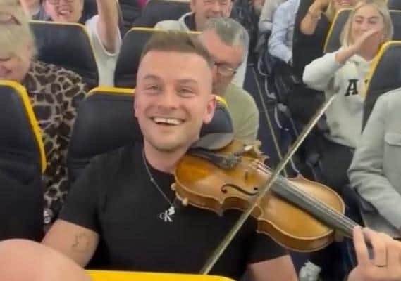 In full flow... striking up the music onboard the Ryanair flight.