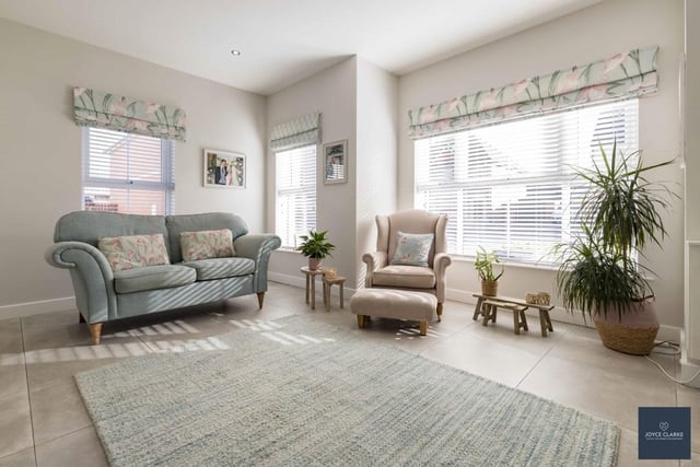 The bright dual aspect living room is a lovely area to relax in with family and friends.