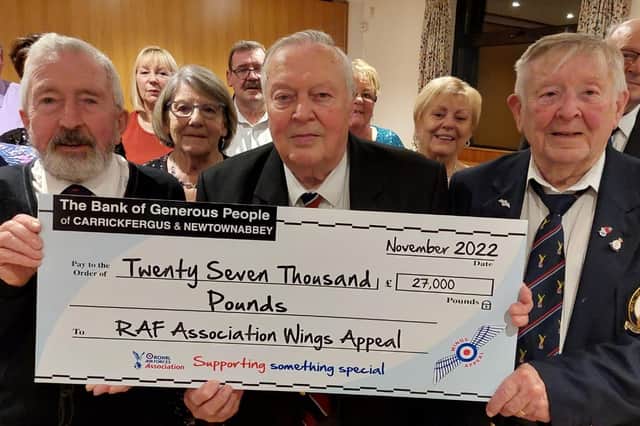 Carrickferugs RAFA's Joe Corr, welfare officer; Kevin McRandle, life vice president and Colin Murphy, past chair, with the Wings Appeal cheque.