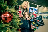 Belfast Film Festival CEO, Michelle Devlin joins Translink Smartmover, Connie Curistan at Belfast Grand Central Station to spread some Christmas cheer with news of a festive cinema on Sunday December 8 with a special screening of the beloved holiday classic Elf. This unique event is in support of two important causes: Translink’s Stuff a Bus appeal on behalf of FareShare NI and Air Ambulance NI.  Pic credit: Translink