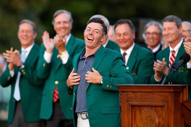 AUGUSTA, GEORGIA - APRIL 13: Rory McIlroy of Northern Ireland reacts as he is awarded the Green Jacket by Masters Champion Scottie Scheffler after the final round of the 2025 Masters Tournament at Augusta National Golf Club on April 13, 2025 in Augusta, Georgia. (Photo by Harry How/Getty Images)