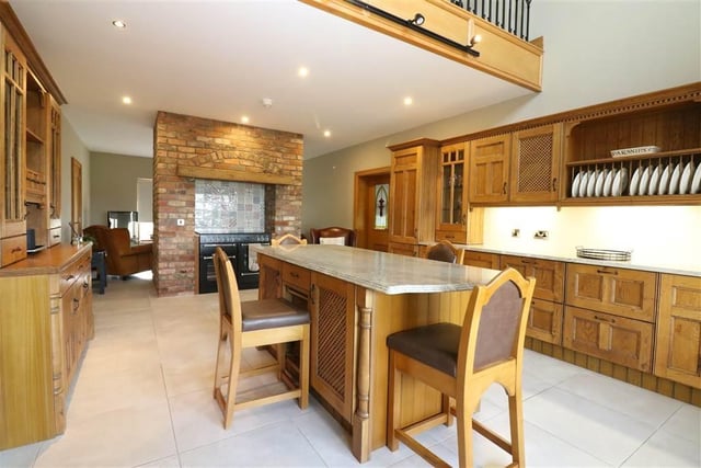 The open plan kitchen area features an extensive range of solid oak high and low level units.