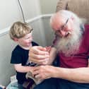 William Shiels with one of his grandchildren. Credit: Submitted