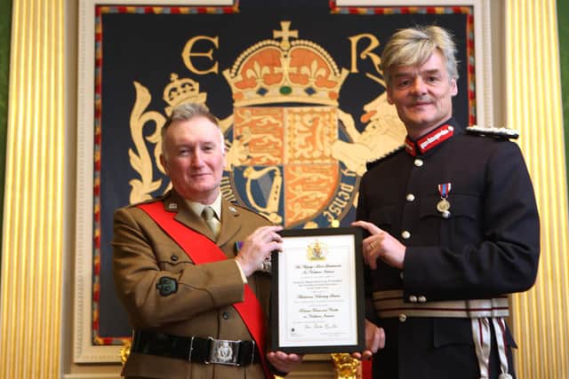Company Sergeant Major Instructor Nigel Gribbon is pictured receiving certificate and congratulations  from Mr Gawn  Rowan-Hamilton, His Majesty’s Lord Lieutenant for the County of Down.