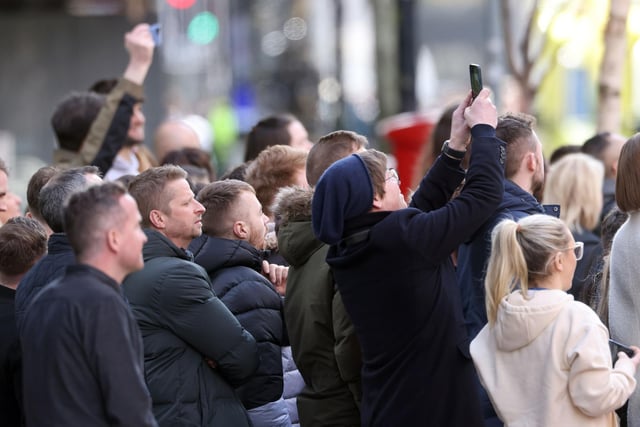 Stretching up to get a picture of US President Joe Biden outside the Grand Central Hotel in Belfast on Wednesday morning. Picture: Stephen Davison.