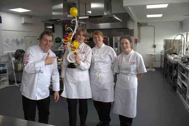 Displaying a sugar showpiece made entirely out of sugar, Master Pâtissier, Florian Poirot, who held a masterclass in sugar and pastry with SERC Level 3 NVQ Diploma in Professional Cookery - Patisserie and Confectionery students Marija Kuzaite (Coalisland), Eimear McCarthy (Kircubbin) and Zara Shiels (Lisburn).