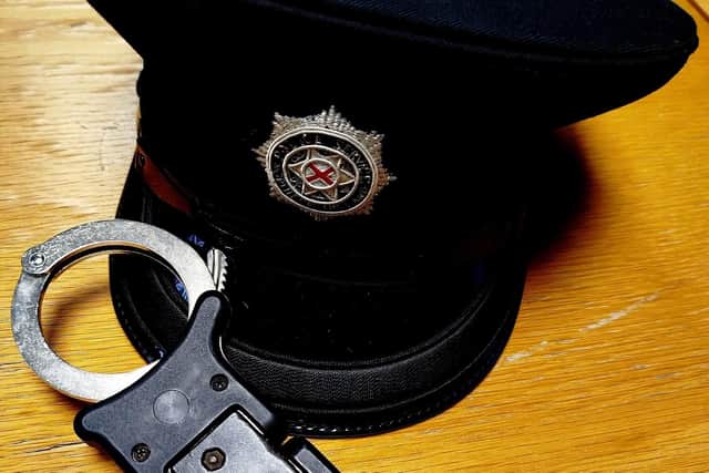 PSNI officer's hat and handcuffs.