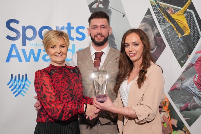 Dawn Sterling presents the Sportsperson of the Year award to Stephen and Sarah Kirkpatrick on behalf of darts player Josh Rock.
