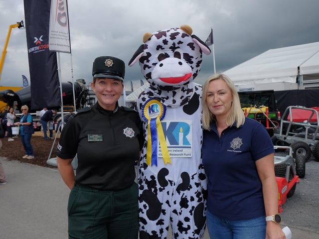 Meeting Northern Ireland Kidney Research Fund 's mascot Bella the Kidney Cow are PSNI Crime Prevention team members.