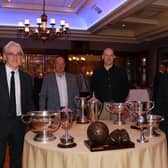 Cormac McKinney, Cathal Murray, Kevin Franklin, Ronan McMahon staff members organising committee standing at the table displaying the many trophies won by St. Colman's College. INNR4832