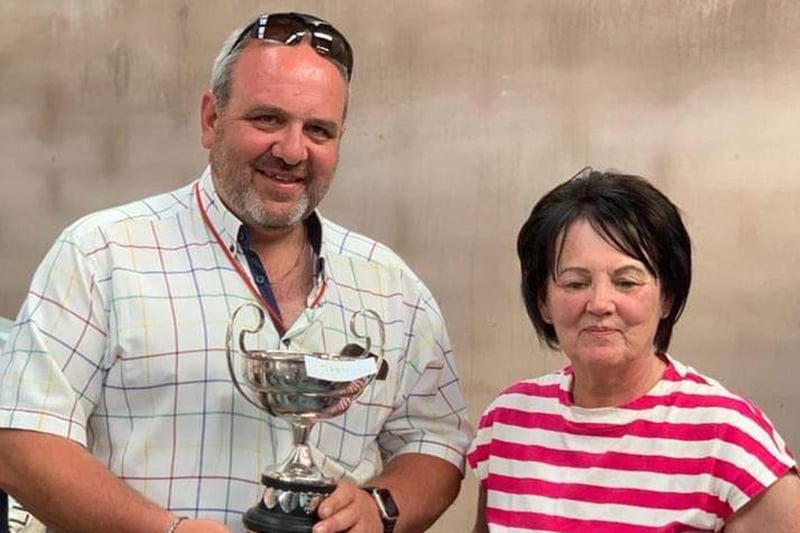 Alastair Lyttle  who won this year's Open Trial at the Glenravel & District Working Sheepdog Society 75th anniversary trials at McFadden's Farm, receives his prize from Colette McFadden
