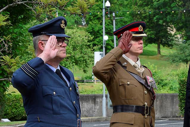 Saluting as the Armed Forces Flag is raised are Wing Commander Steve McCleery and Lieutenant Colonel Simon Whittaker. Pic Credit: Lisburn and Castlereagh City Council