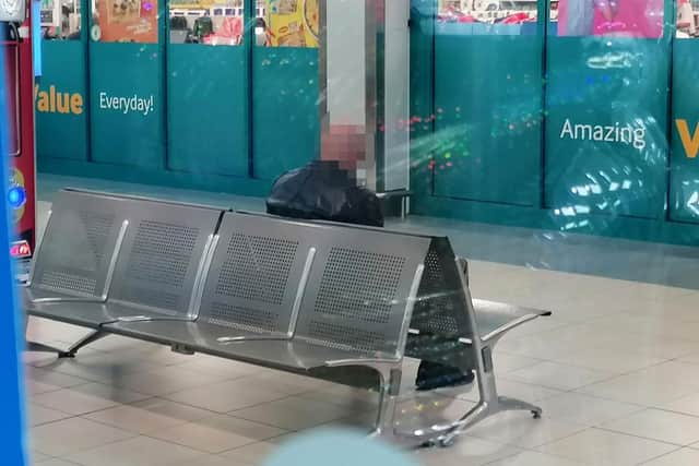 The suspect pictured in the shopping centre before being apprehended by police.