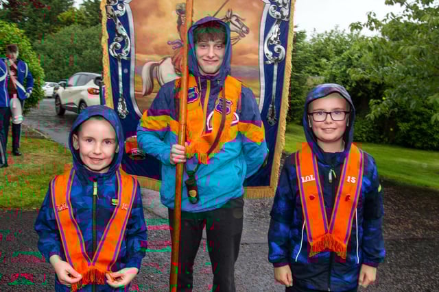 Getting wet but looking happy at the Lurgan Mini 12th are from left, Henry Stevenson, Matthew Girvan and George Stevenson. LM27-206.