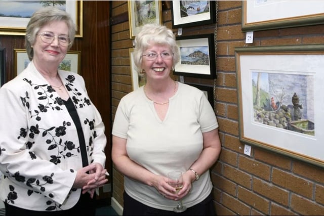 Angela M Stevenson and Victoria McMillan discussing some of the pieces by Carrick Art Club members on display at a 2007 exhibition in Carrick Library.