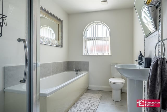 Family bathroom with modern fitted four piece suite comprising panelled bath, shower cubicle with mains shower over, wash hand basin and WC. Part tiled walls and tiled floor.