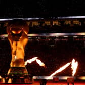 AL KHOR, QATAR - NOVEMBER 25: A fire display surrounds a giant FIFA trophy prior to the match between the United States and England during the FIFA World Cup Qatar 2022 Group B match between England and USA at Al Bayt Stadium on November 25, 2022 in Al Khor, Qatar. (Photo by Elsa/Getty Images)