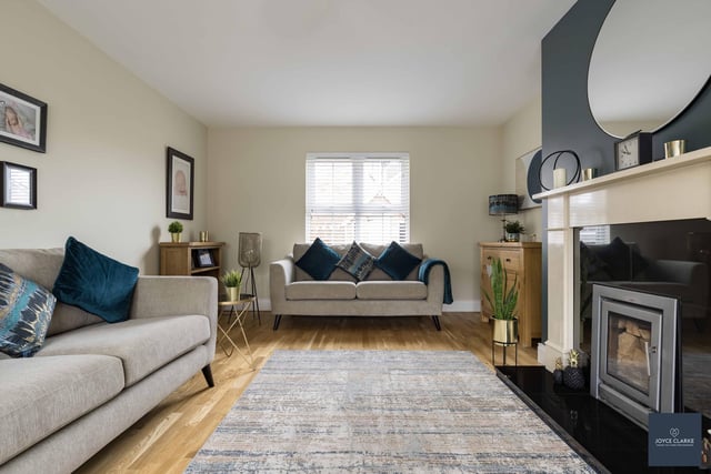 The attractive living room has a feature fireplace with cassette stove, stone surround, granite hearth and back panel, TV and telephone points. There is also a wood effect laminate flooring.
