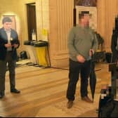 Michelle O'Neill says she did not know the whereabouts of her former colleague Michael McMonagle (left, highlighted) during the period this image was taken. This still from a video taken by BBC Northern Ireland in February 2023 shows Michelle O'Neill standing a few yards from him. The SF politician was deputy first minister when she employed McMonagle in 2020.