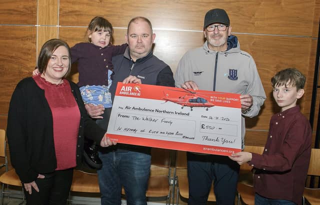 Band member, Paul Ross, pictured receiving a cheque for £550 from the Walker family, Alan, Kendal, George and Beth. The money was raised at Alan's 40th birthday and will go towards Air Ambulance in memory of Paul's late wife Ruth and daughter Lydia.