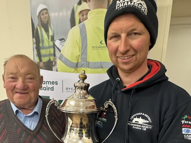 Chairman Martin Gill presents Andrew Gill his trophy as Champion of the Field at Listooder Ploughing Match