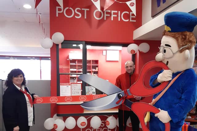 Cutting the ribbon to officially open the new Gilpinstown Road Post Office in Lurgan.