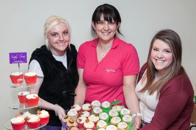 Joanne Trimble with Christian and Laura Glass from Simply Devine with her special Hospice cupcakes at the 2012 fashion show in the Knockagh Lodge.