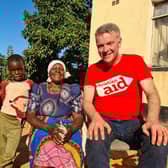 Widowed grandmother Loveness Chapano and her grandsons, Liberty (7) and Litzani (5), outside their newly built home in Ndiyadzo village in the Chipinge region of Zimbabwe, pictured with Ian Mullen, a teaching assistant and Christian Aid supporter from Anahilt. Pic credit: Christian Aid