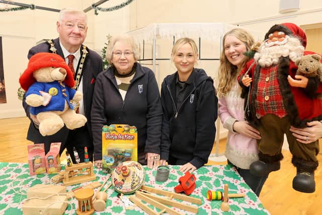 Mayor of Causeway Coast and Glens, Councillor Steven Callaghan alongside Kathleen Walker, Lynda Bartlett and Museum Officer Jamie Austin with several of the toys from days gone by which are featured within the exhibition.